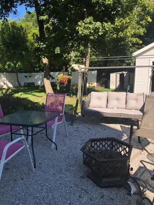 a patio with a couch and a table and chairs at Suite Serenity in Cleveland