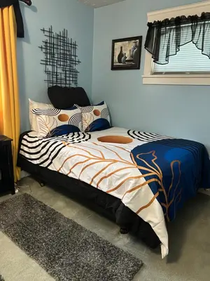 a bedroom with a bed with a zebra blanket at Suite Serenity in Cleveland
