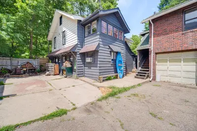 a home with a blue house with a garage at 7 Mi to Cuyahoga Valley NP Walkable Apt! in Cuyahoga Falls