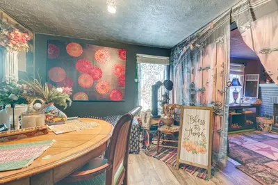 a dining room with a table and chairs and a room with colorful walls at 7 Mi to Cuyahoga Valley NP Walkable Apt! in Cuyahoga Falls