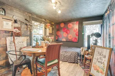 a room with a table and chairs and a bedroom at 7 Mi to Cuyahoga Valley NP Walkable Apt! in Cuyahoga Falls