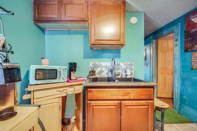 a kitchen with a sink and a microwave at 7 Mi to Cuyahoga Valley NP Walkable Apt! in Cuyahoga Falls
