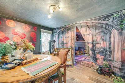 a dining room with a table and a painting on the wall at 7 Mi to Cuyahoga Valley NP Walkable Apt! in Cuyahoga Falls