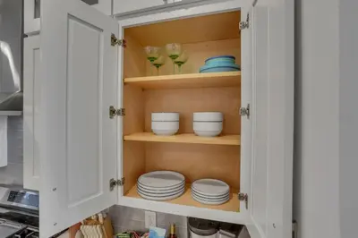 a kitchen cabinet with plates and bowls in it at The Heron House