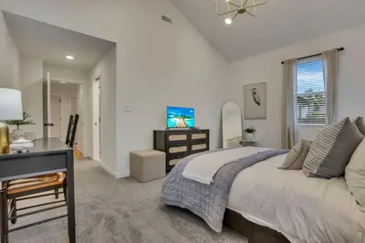 a bedroom with a bed and a desk and a computer at The Heron House