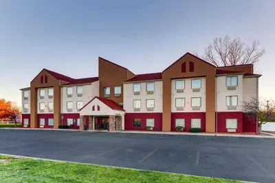 a large building with a parking lot in front of it at Red Roof Inn Springfield, OH in Springfield