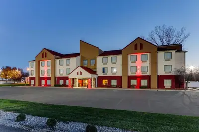 a large building with red doors on a street at Red Roof Inn Springfield, OH in Springfield