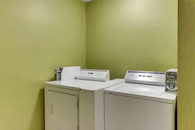 a laundry room with a washer and dryer at Red Roof Inn Springfield, OH in Springfield