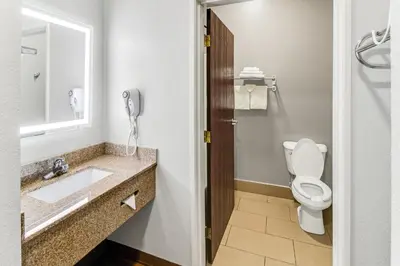 a bathroom with a toilet and a sink and a phone at Red Roof Inn Springfield, OH in Springfield