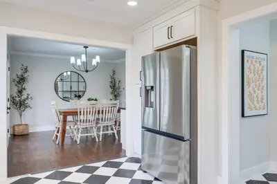 a kitchen and dining room with a refrigerator and a table at Explore Cleveland Attractions! Family-Focused Home in Shaker Heights