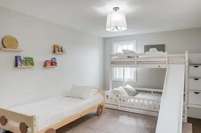 a bedroom with two bunk beds and a crib at Explore Cleveland Attractions! Family-Focused Home in Shaker Heights