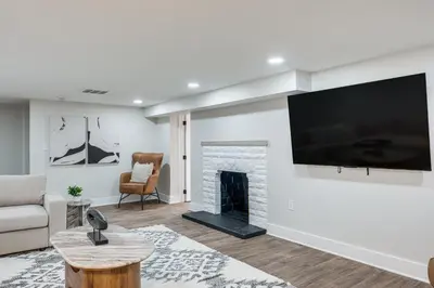 a living room with a fireplace and a flat screen tv at Explore Cleveland Attractions! Family-Focused Home in Shaker Heights