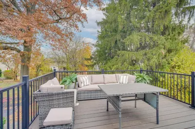 a patio with a couch and a table on a fence at Explore Cleveland Attractions! Family-Focused Home in Shaker Heights
