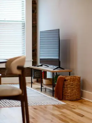 a desk with a monitor and a chair in a room at The Brick Treasury Loft in Cleveland