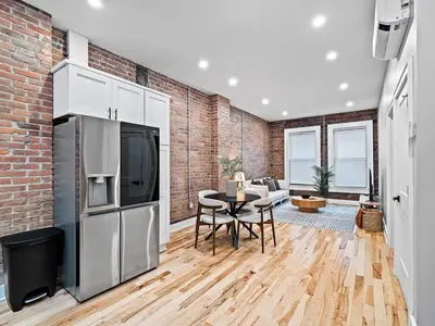 a kitchen and dining room with a brick wall at The Brick Treasury Loft in Cleveland
