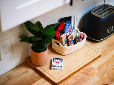 a table with a potted plant and a basket of snacks at The Brick Treasury Loft in Cleveland