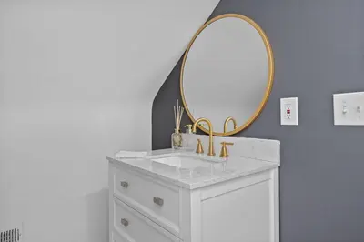 a bathroom with a white sink and a mirror at Luxury 5BR Cincinnati, Sleeps 12, Crib, Home Gym, Fenced Backyard in Cincinnati