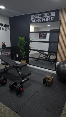 a room with a gym with a treadmill and a mirror at Luxury 5BR Cincinnati, Sleeps 12, Crib, Home Gym, Fenced Backyard in Cincinnati