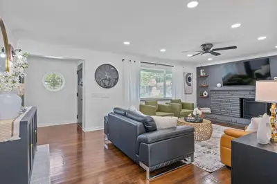 a living room with a couch and a tv at Luxury 5BR Cincinnati, Sleeps 12, Crib, Home Gym, Fenced Backyard in Cincinnati