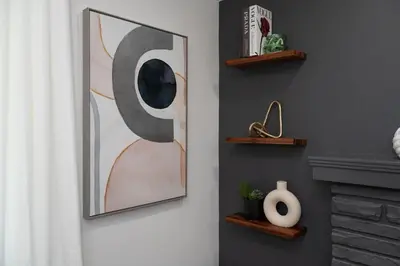 a living room with a painting on the wall at Luxury 5BR Cincinnati, Sleeps 12, Crib, Home Gym, Fenced Backyard in Cincinnati