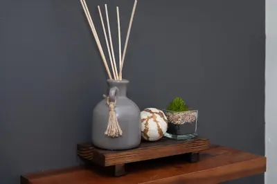 a vase and seashells on a wooden shelf at Luxury 5BR Cincinnati, Sleeps 12, Crib, Home Gym, Fenced Backyard in Cincinnati