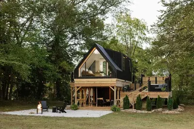 a tiny house in the middle of a forest at The Alto in Logan