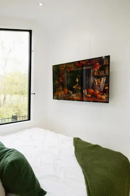 a living room with a bed and a picture on the wall at The Alto in Logan