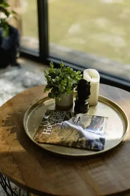 a plate on a table with a plant and a candle at The Alto in Logan