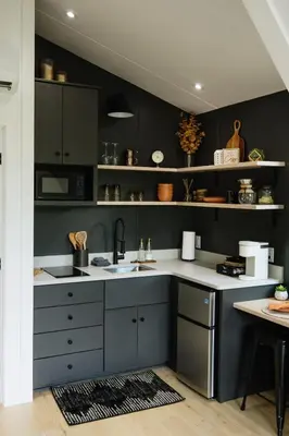 a kitchen with black walls and a sink and a counter at The Alto in Logan