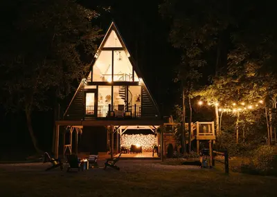 a house lit up at night with lights at The Pinnacle in Logan