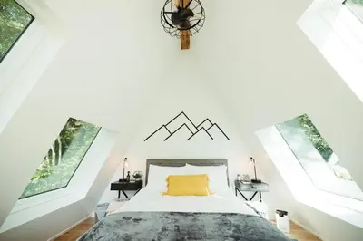 a bedroom with a bed and two windows at The Pinnacle in Logan