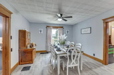 a dining room with a table and a ceiling fan at 5 Mi to The Wilds Spacious Family Hub, Game Room!