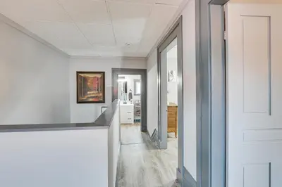 a hallway with white walls and a white door at 5 Mi to The Wilds Spacious Family Hub, Game Room!
