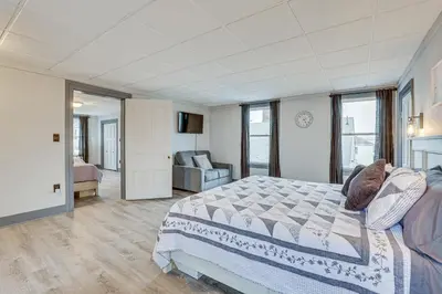 a bedroom with a bed and a chair in it at 5 Mi to The Wilds Spacious Family Hub, Game Room!