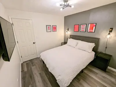 a bedroom with a white bed and a white door at Downtown 3 Bed Loft Apartment in Delaware