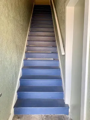 a flight of blue stairs in a house at Downtown 3 Bed Loft Apartment in Delaware
