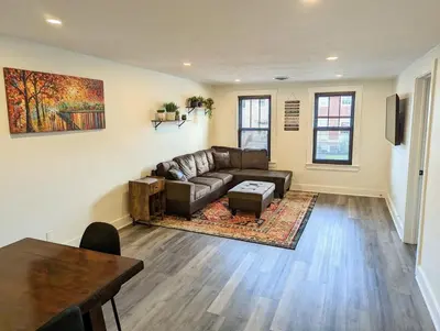 a living room with a couch and a table at Downtown 3 Bed Loft Apartment in Delaware