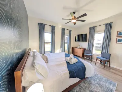 a bedroom with a large bed with a ceiling fan at Modern Norwalk Retreat 2 King Suites Sunroom in Norwalk