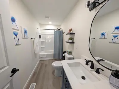 a white bathroom with a sink and a toilet at Modern Norwalk Retreat 2 King Suites Sunroom in Norwalk