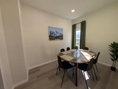 a dining room with a wooden table and chairs at Modern Norwalk Retreat 2 King Suites Sunroom in Norwalk