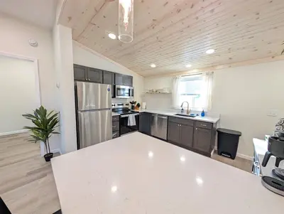 a kitchen with a white counter top in a room at Modern Norwalk Retreat 2 King Suites Sunroom in Norwalk