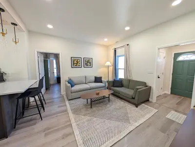 a living room with two couches and a table at Modern Norwalk Retreat 2 King Suites Sunroom in Norwalk