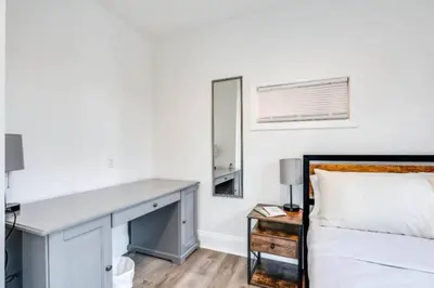 a bedroom with a bed and a mirror at Cozy Old Brooklyn Home near Zoo in Cleveland