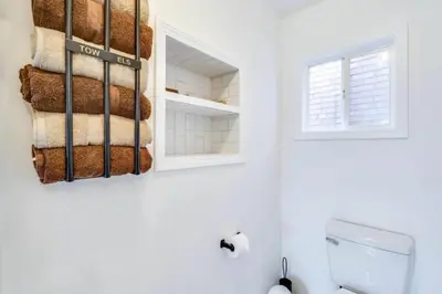 a bathroom with a towel rack and a toilet at Cozy Old Brooklyn Home near Zoo in Cleveland