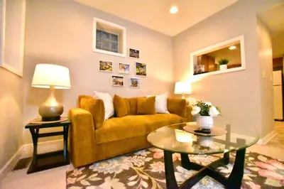 a living room with a couch and a table at Tremont apartment, near downtown, and Central! in Cleveland
