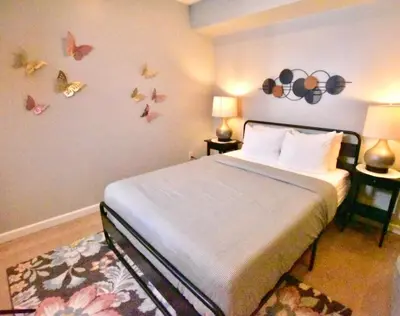 a bedroom with a bed with butterflies on the wall at Tremont apartment, near downtown, and Central! in Cleveland