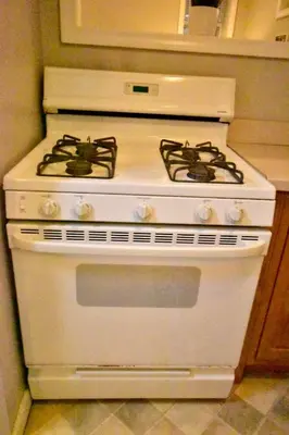 a white stove with two burners in a kitchen at Tremont apartment, near downtown, and Central! in Cleveland