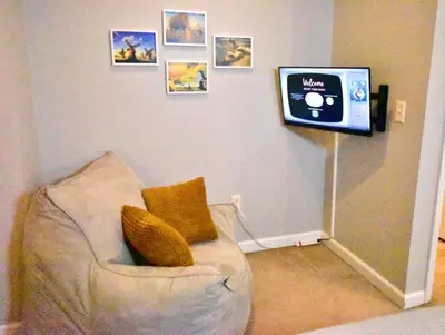 a living room with a couch and a tv at Tremont apartment, near downtown, and Central! in Cleveland