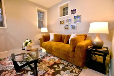 a living room with a couch and a glass table at Tremont apartment, near downtown, and Central! in Cleveland