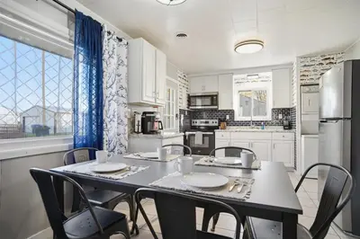 a kitchen with a table and chairs and a refrigerator at Angler's Cottage with Boat Parking by Lake Erie in Port Clinton
